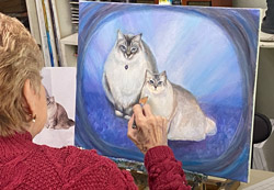 Adult student painting blue cats portrait in Tarzana studio