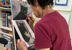 Adult student painting two cats portrait in Tarzana studio